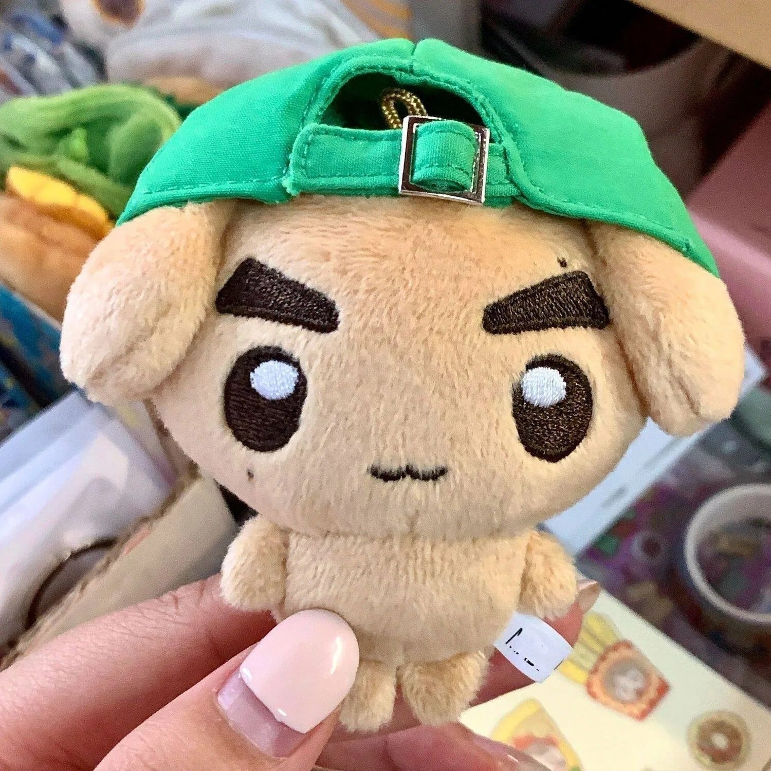 CORTIS Keonho Puppy plush face and green cap close-up